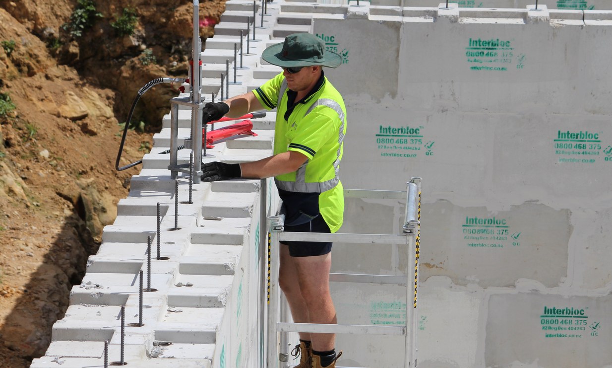 Interbloc concrete blocks securing a temporary site perimeter fence