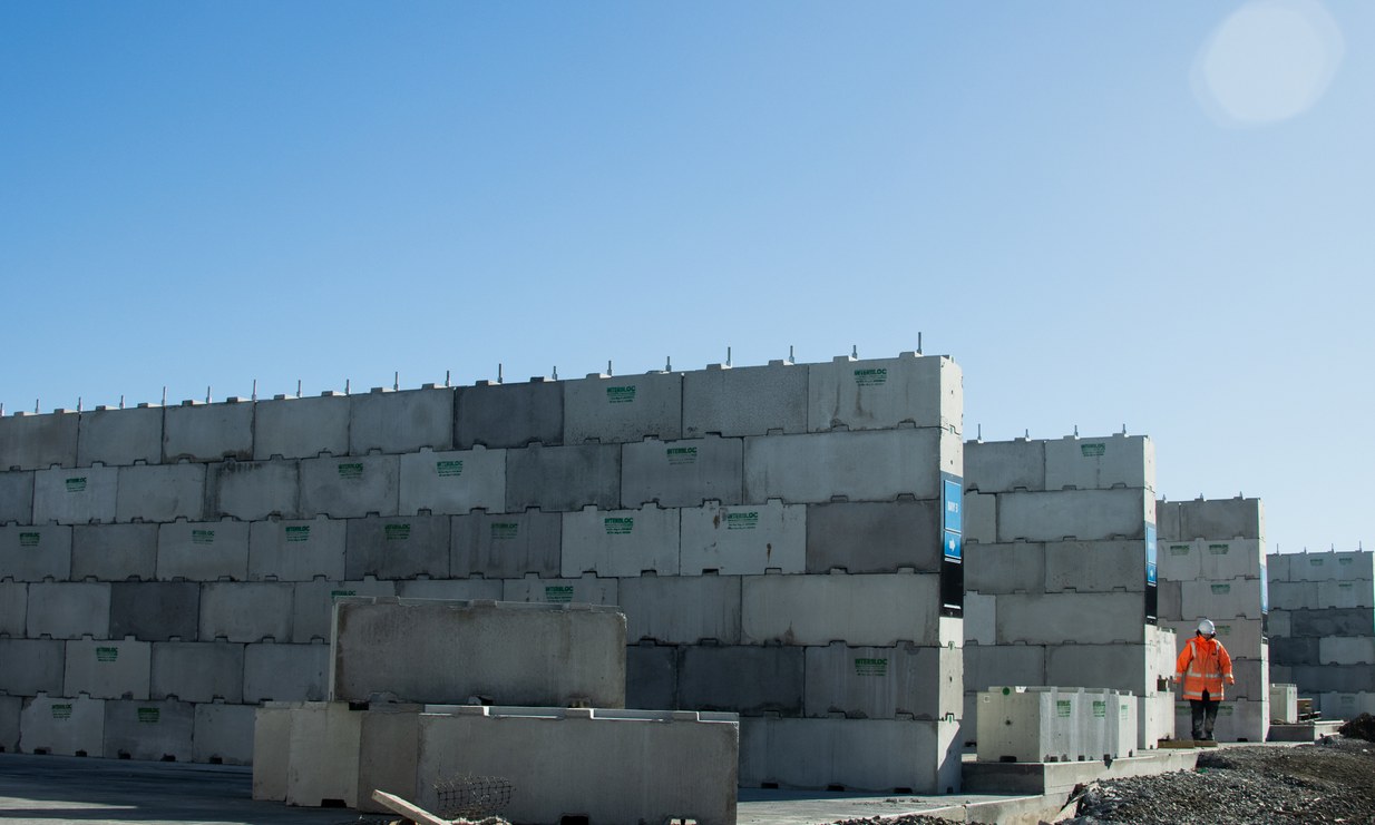 Interbloc concrete blocks securing a temporary site perimeter fence