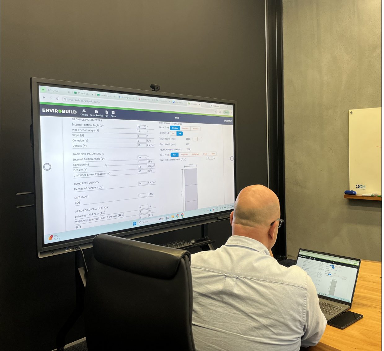 Engineer reviewing Envirocalc structural checks on a large screen