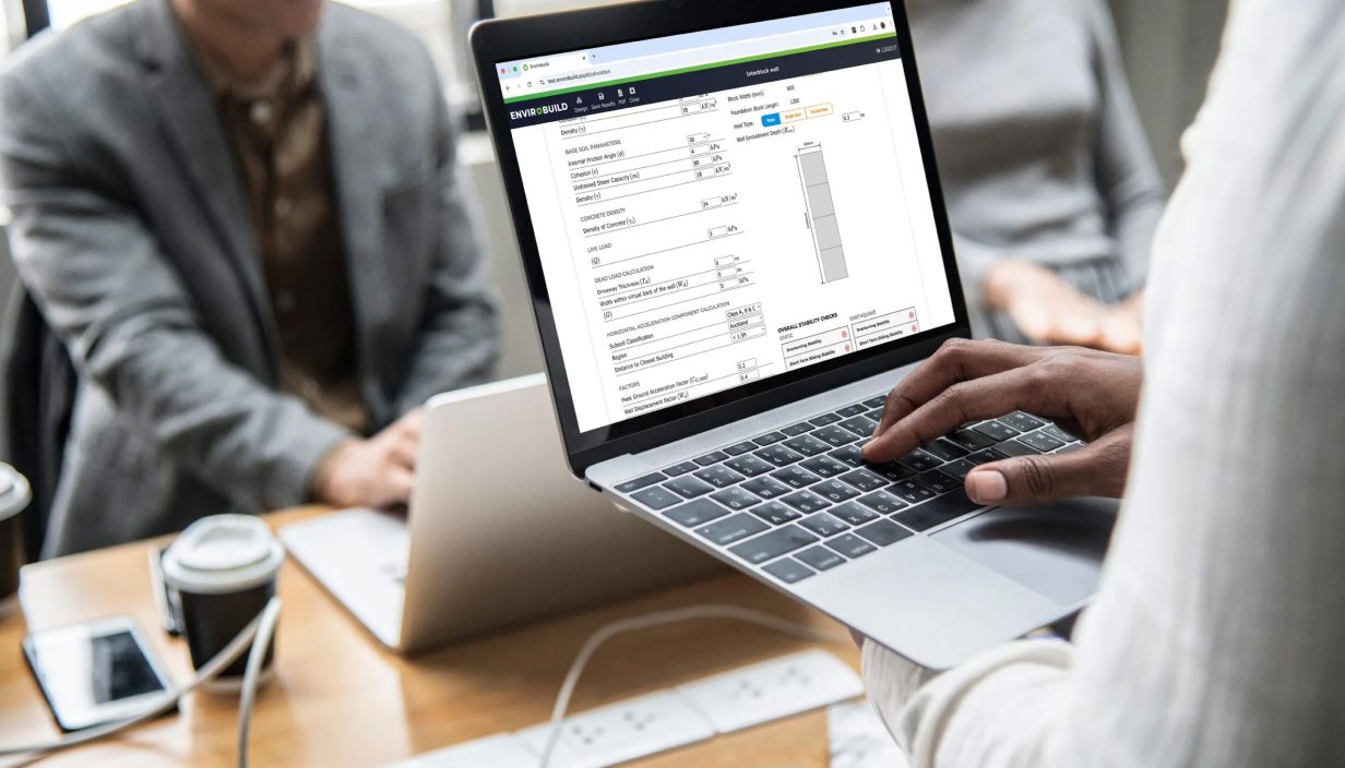 Engineer reviewing an Envirocalc design report on a laptop