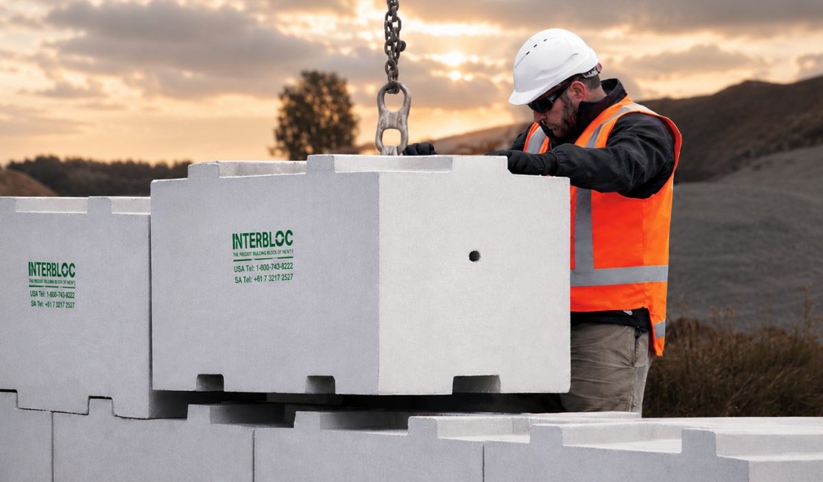 Install crew placing an Interbloc block at sunset
