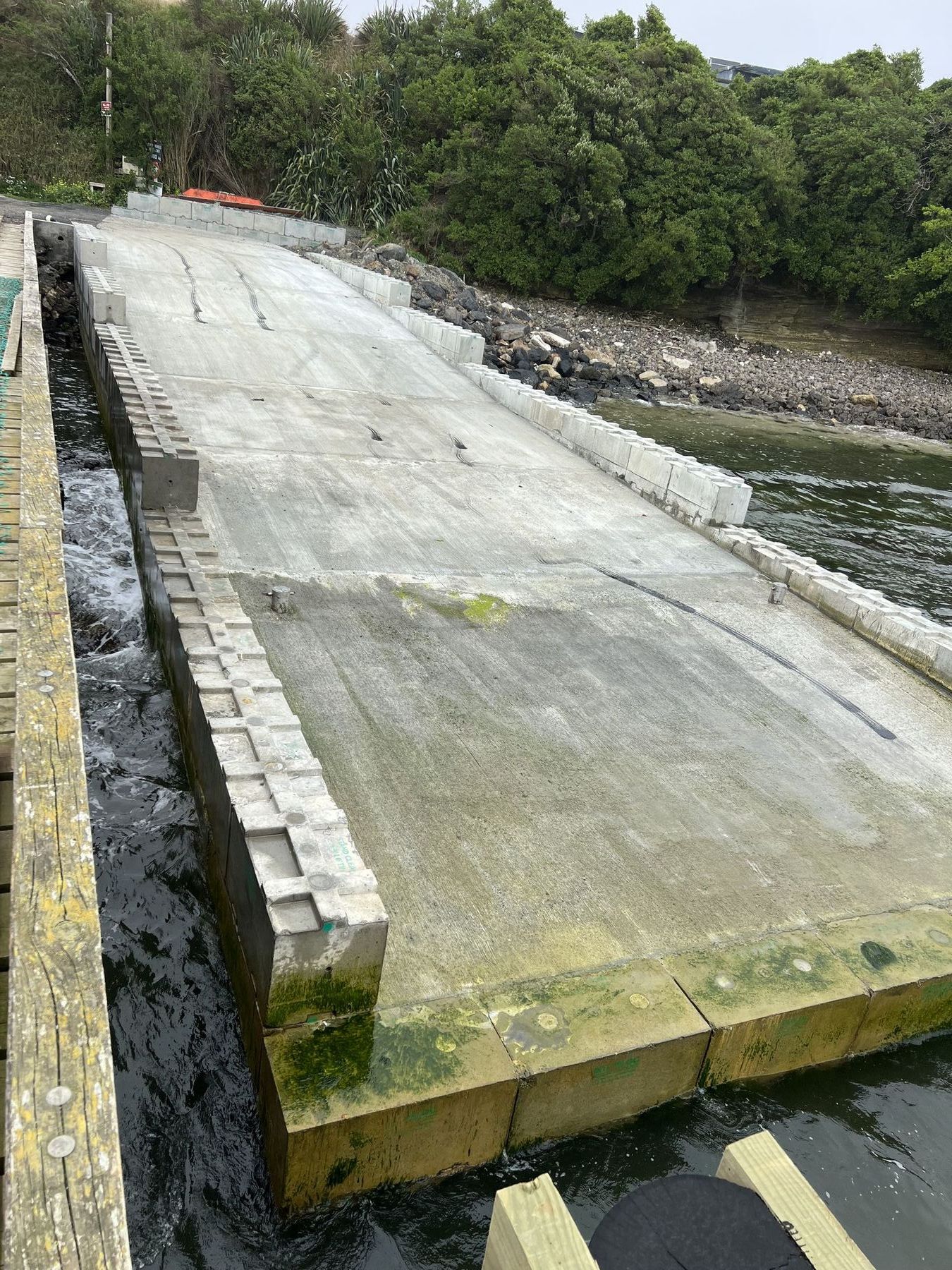 Completed rock-anchored marine ramp at Owenga, Chatham Islands, seen from above at low tide