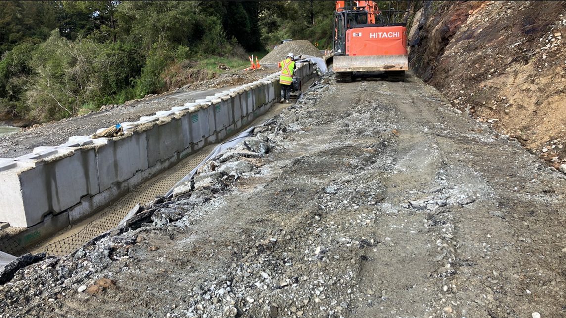 Excavator placing Interbloc blocks along the SH6 Coal Creek remediation site