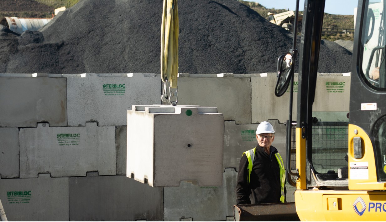 Crane lifting an Interbloc block onto a stack at a quarry site