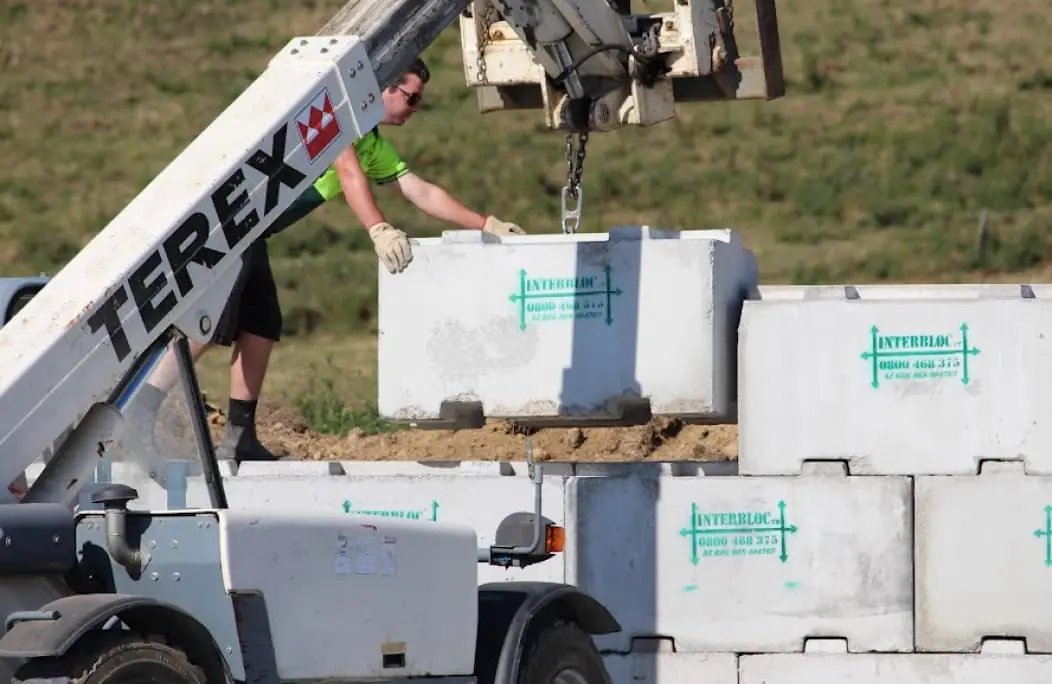 Crane lifting an Interbloc block into place